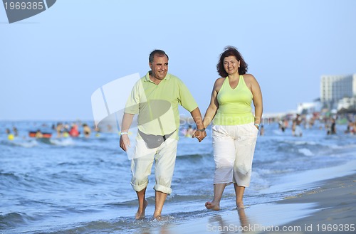 Image of happy seniors couple  on beach