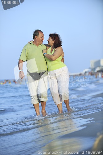 Image of happy seniors couple  on beach