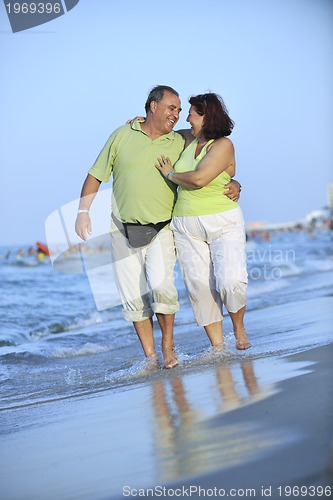 Image of happy seniors couple  on beach