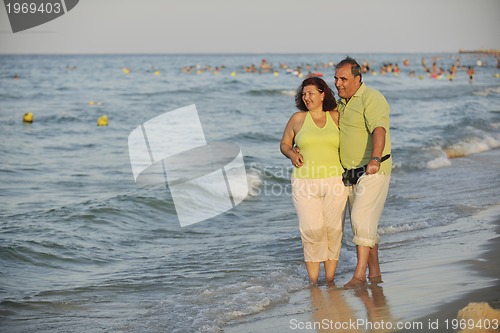 Image of happy seniors couple  on beach