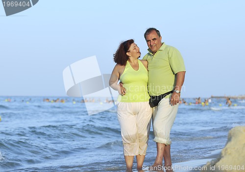 Image of happy seniors couple  on beach