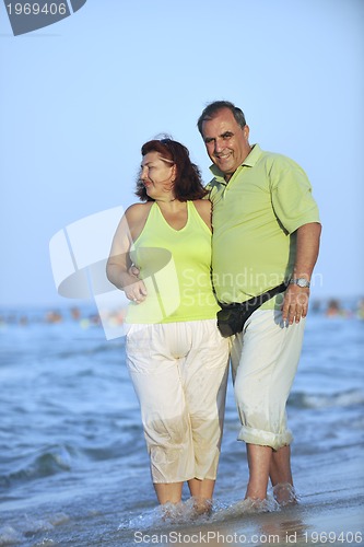 Image of happy seniors couple  on beach