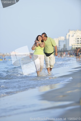 Image of happy seniors couple  on beach