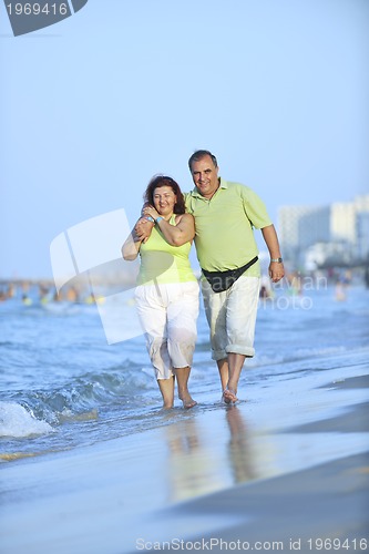 Image of happy seniors couple  on beach