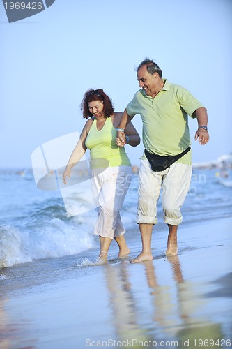 Image of happy seniors couple  on beach