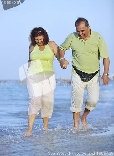 Image of happy seniors couple  on beach