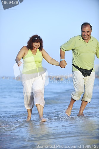 Image of happy seniors couple  on beach