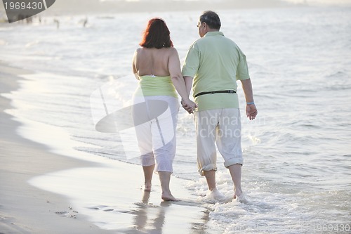 Image of happy seniors couple  on beach