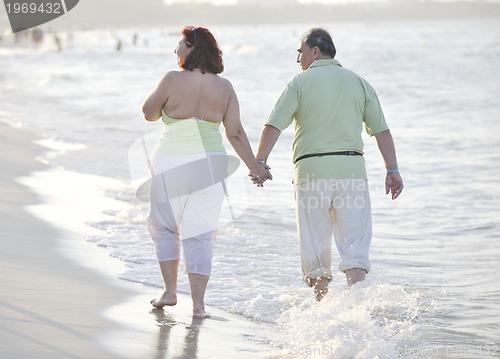 Image of happy seniors couple  on beach