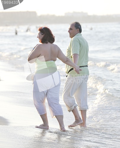 Image of happy seniors couple  on beach