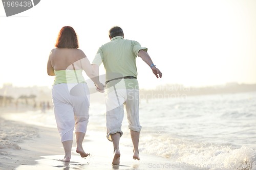 Image of happy seniors couple  on beach