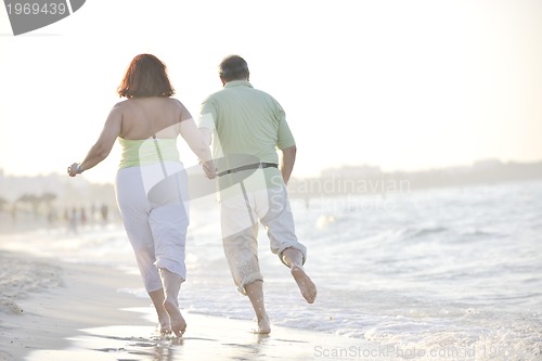 Image of happy seniors couple  on beach