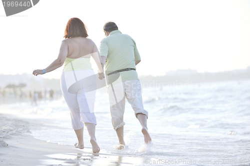 Image of happy seniors couple  on beach