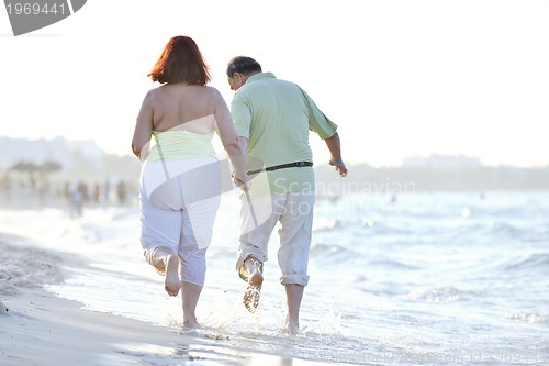 Image of happy seniors couple  on beach