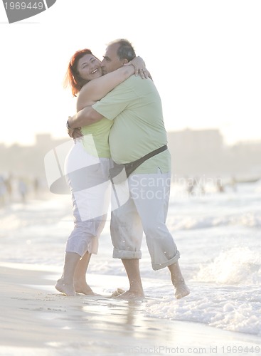 Image of happy seniors couple  on beach