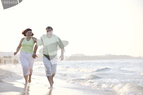 Image of happy seniors couple  on beach