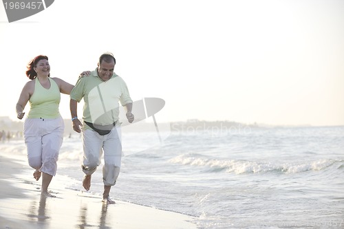 Image of happy seniors couple  on beach