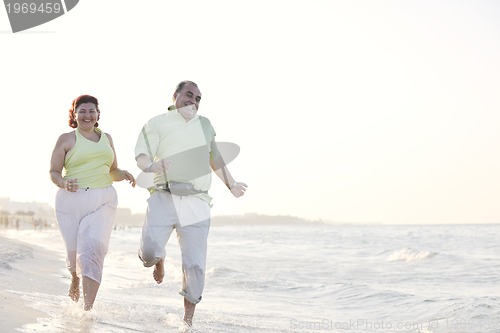 Image of happy seniors couple  on beach