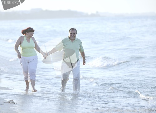 Image of happy seniors couple  on beach