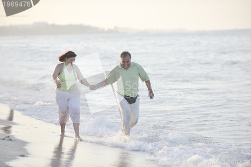 Image of happy seniors couple  on beach