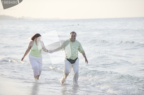 Image of happy seniors couple  on beach