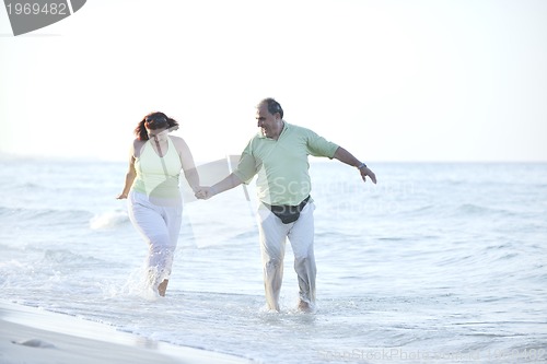 Image of happy seniors couple  on beach