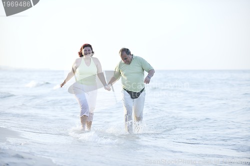 Image of happy seniors couple  on beach