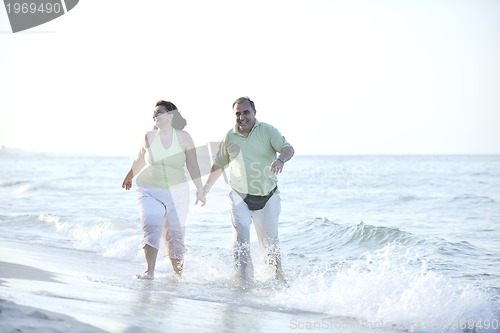 Image of happy seniors couple  on beach