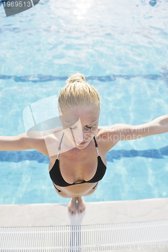Image of beautiful woman relax on swimming pool