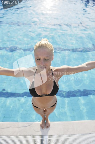 Image of beautiful woman relax on swimming pool