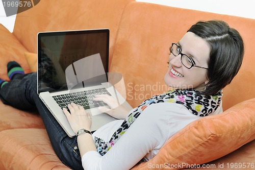 Image of one young woman working on laptop 