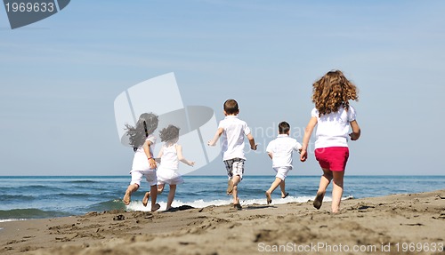Image of happy child group playing  on beach