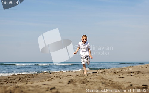 Image of little boy running on beach
