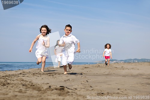 Image of happy child group playing  on beach