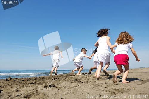 Image of happy child group playing  on beach