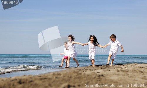 Image of happy child group playing  on beach
