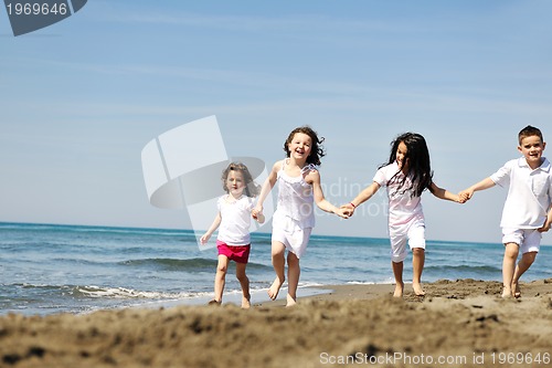 Image of happy child group playing  on beach