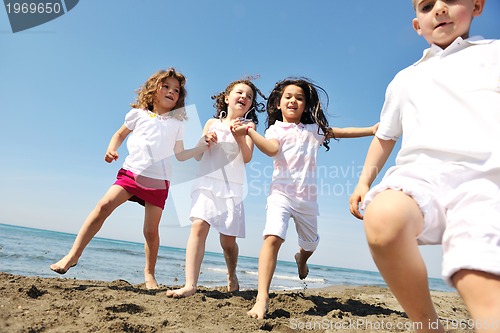 Image of happy child group playing  on beach