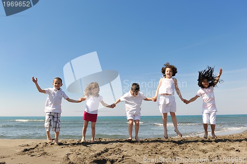 Image of happy child group playing  on beach