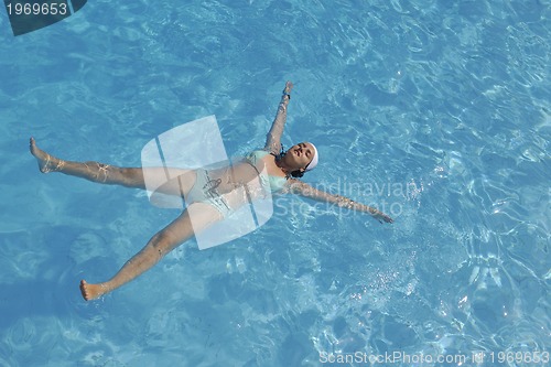 Image of woman relax at swimming pool 