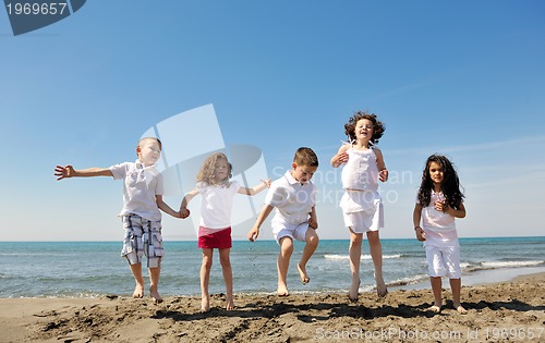 Image of happy child group playing  on beach