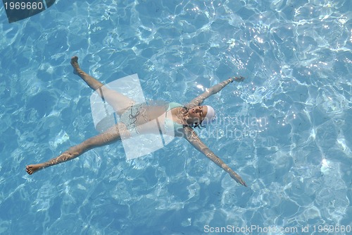 Image of woman relax at swimming pool 