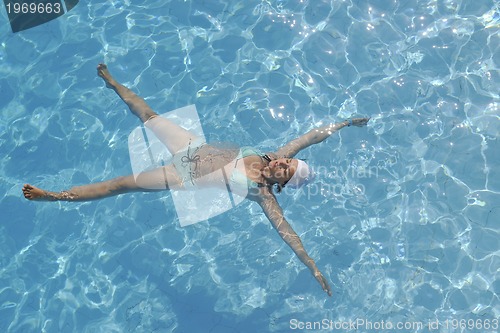 Image of woman relax at swimming pool 