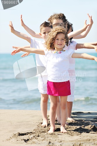 Image of happy child group playing  on beach