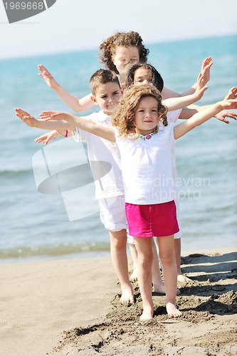 Image of happy child group playing  on beach