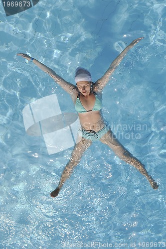 Image of woman relax at swimming pool 