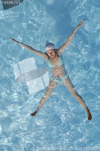 Image of woman relax at swimming pool 