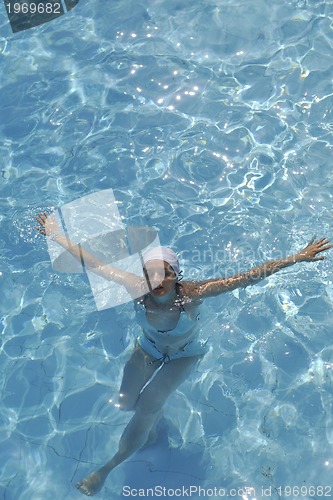 Image of woman relax at swimming pool 