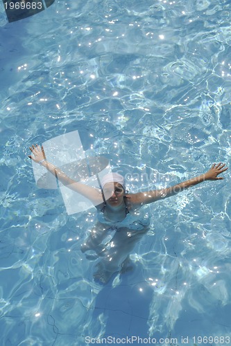 Image of woman relax at swimming pool 