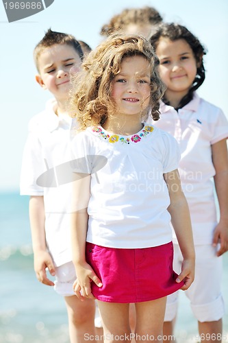 Image of happy child group playing  on beach